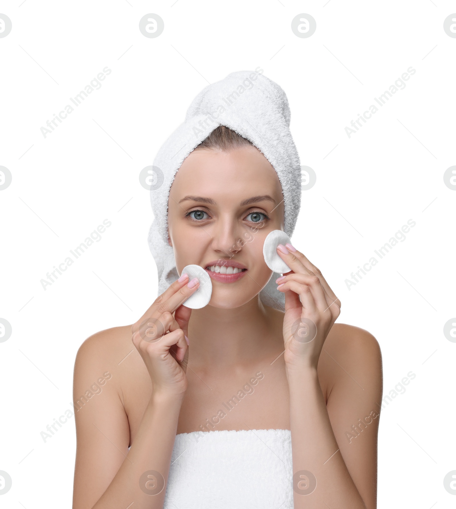 Photo of Young woman cleaning her face with cotton pad on white background