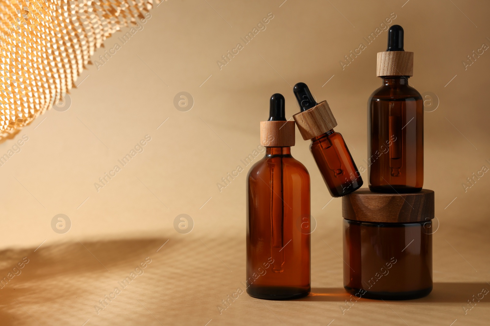 Photo of Set with different luxury cosmetic products on dark beige background, space for text