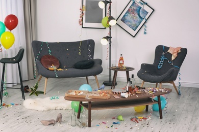 Photo of Messy living room interior. After party chaos