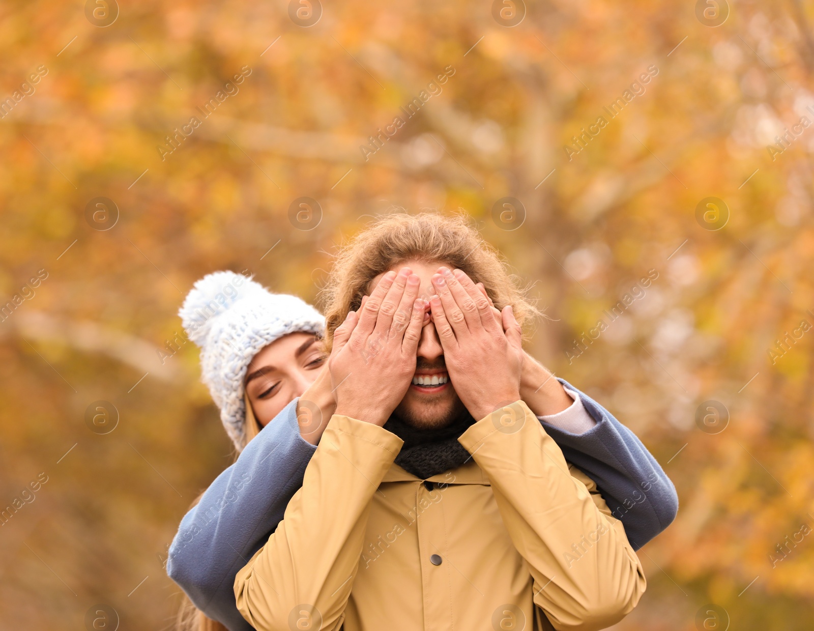 Photo of Young romantic couple having fun in park on autumn day