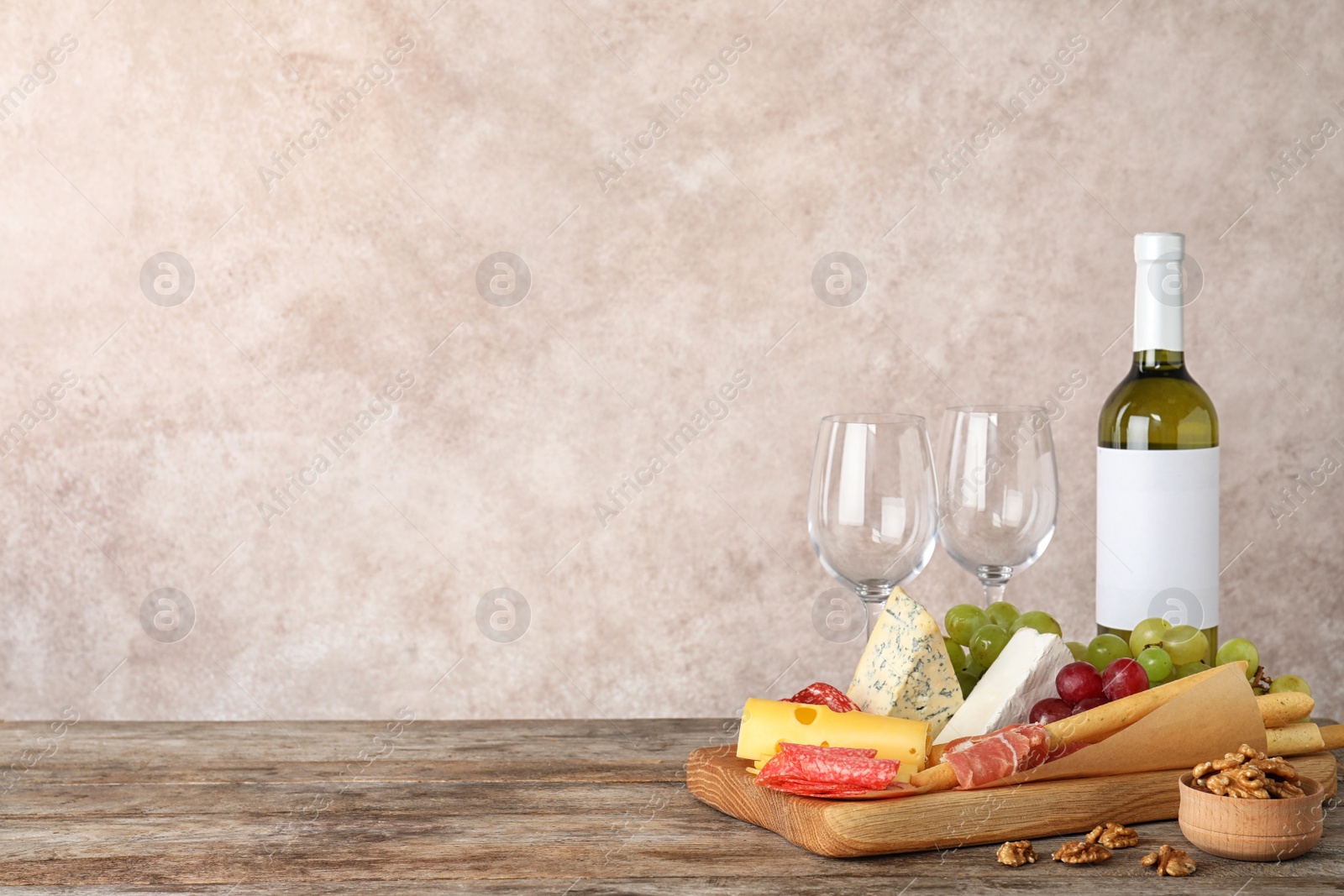 Photo of Composition with wine and snacks on table. Space for text