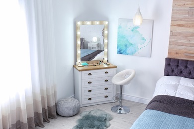 Room interior with makeup mirror, dressing table and bed