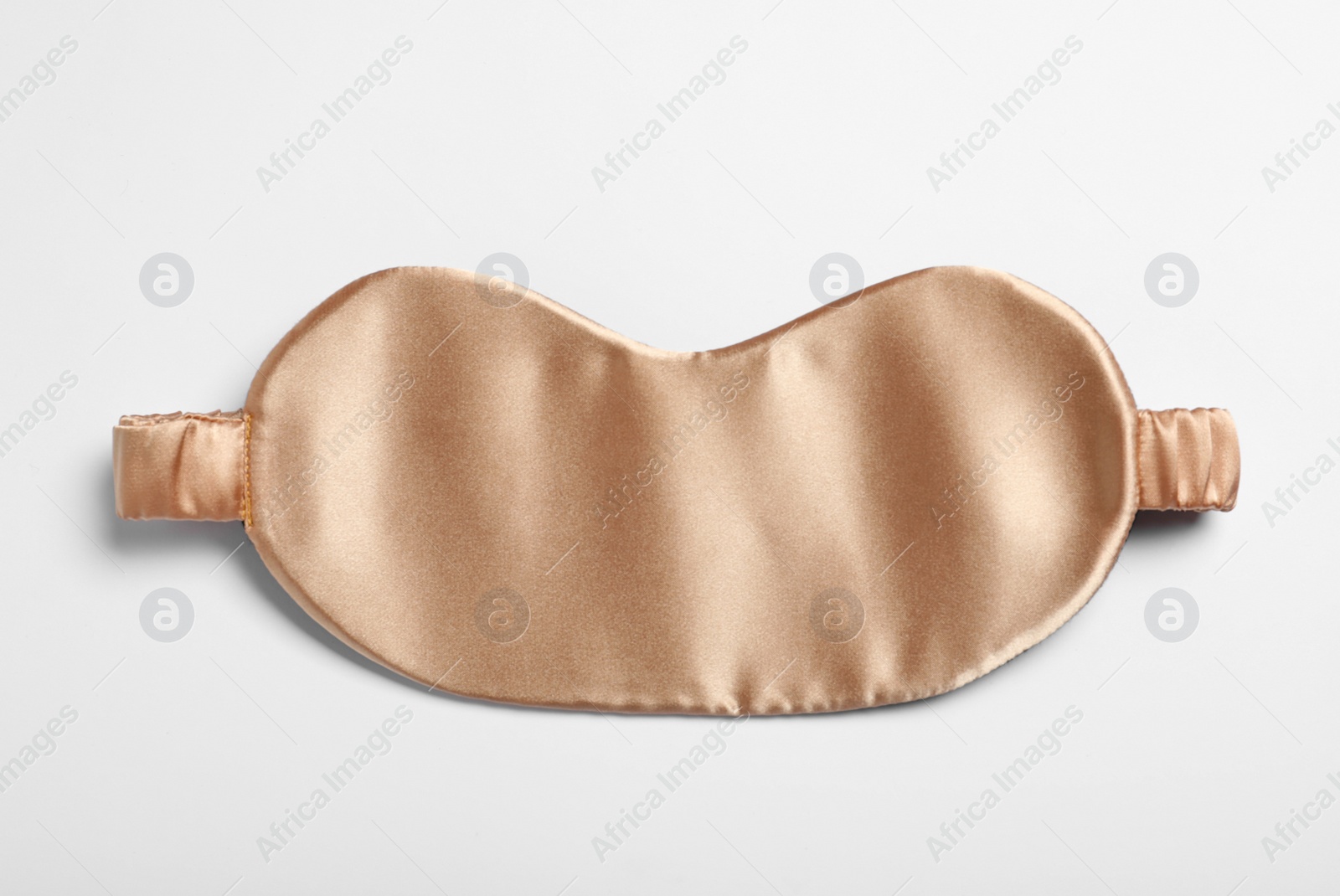 Photo of Beige sleeping mask isolated on white, top view. Bedtime accessory