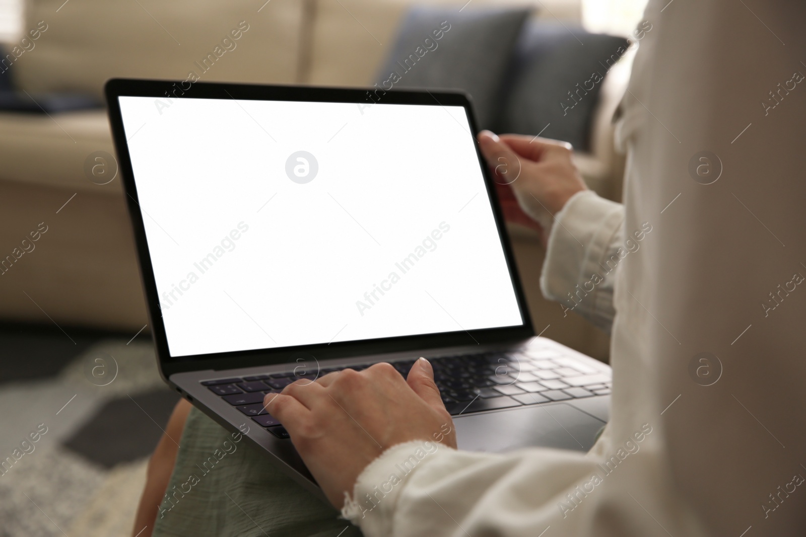 Photo of Woman using laptop at home, closeup. Space for design