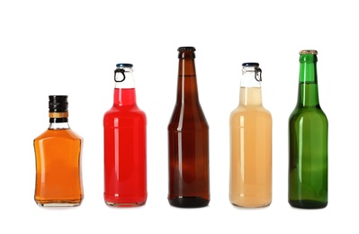 Photo of Bottles with different alcoholic drinks on white background