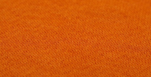 Photo of Texture of soft orange fabric as background, closeup