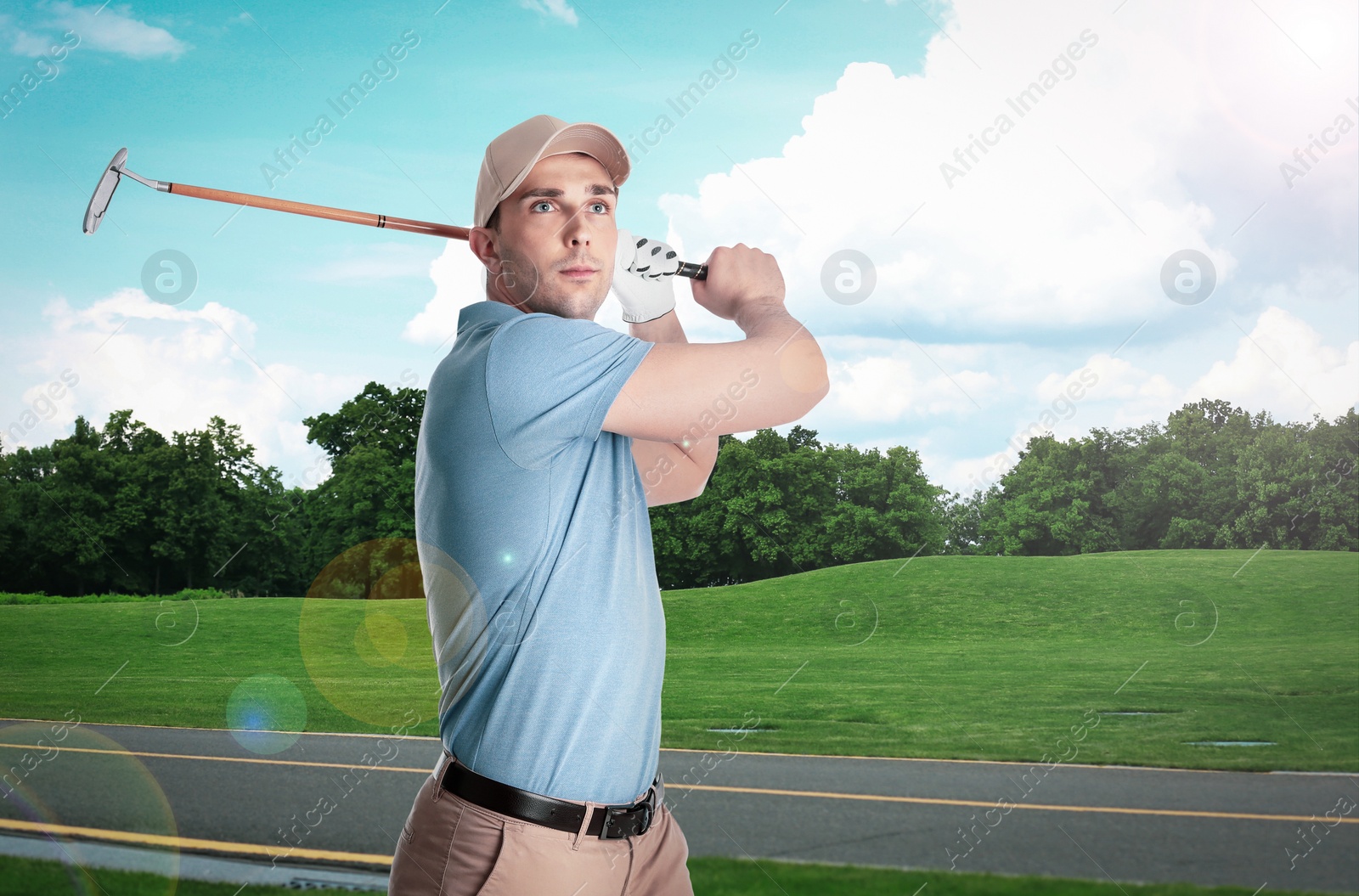 Image of Young man playing golf on course with green grass