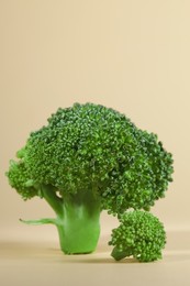 Fresh raw broccoli on beige background, closeup