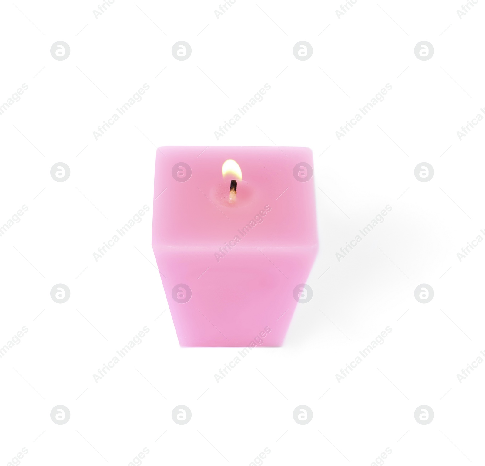 Photo of Small burning pink candle isolated on white