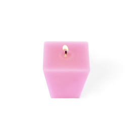 Photo of Small burning pink candle isolated on white