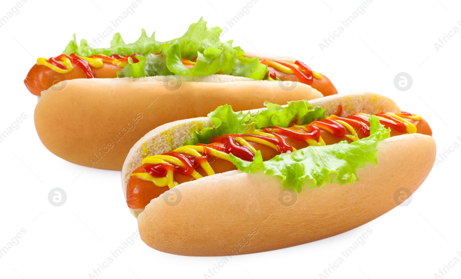 Photo of Tasty hot dogs with lettuce, ketchup and mustard isolated on white