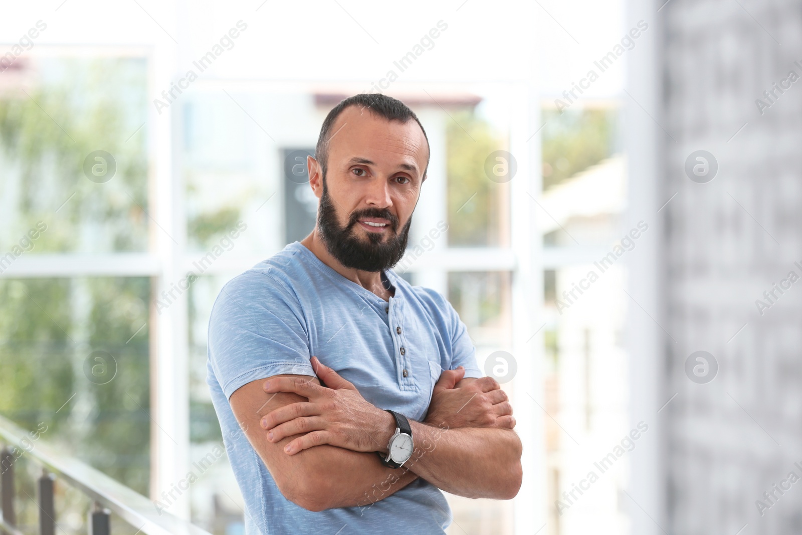 Photo of Portrait of handsome mature man on blurred background