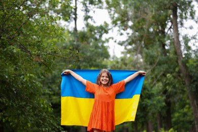 Teenage girl with flag of Ukraine outdoors