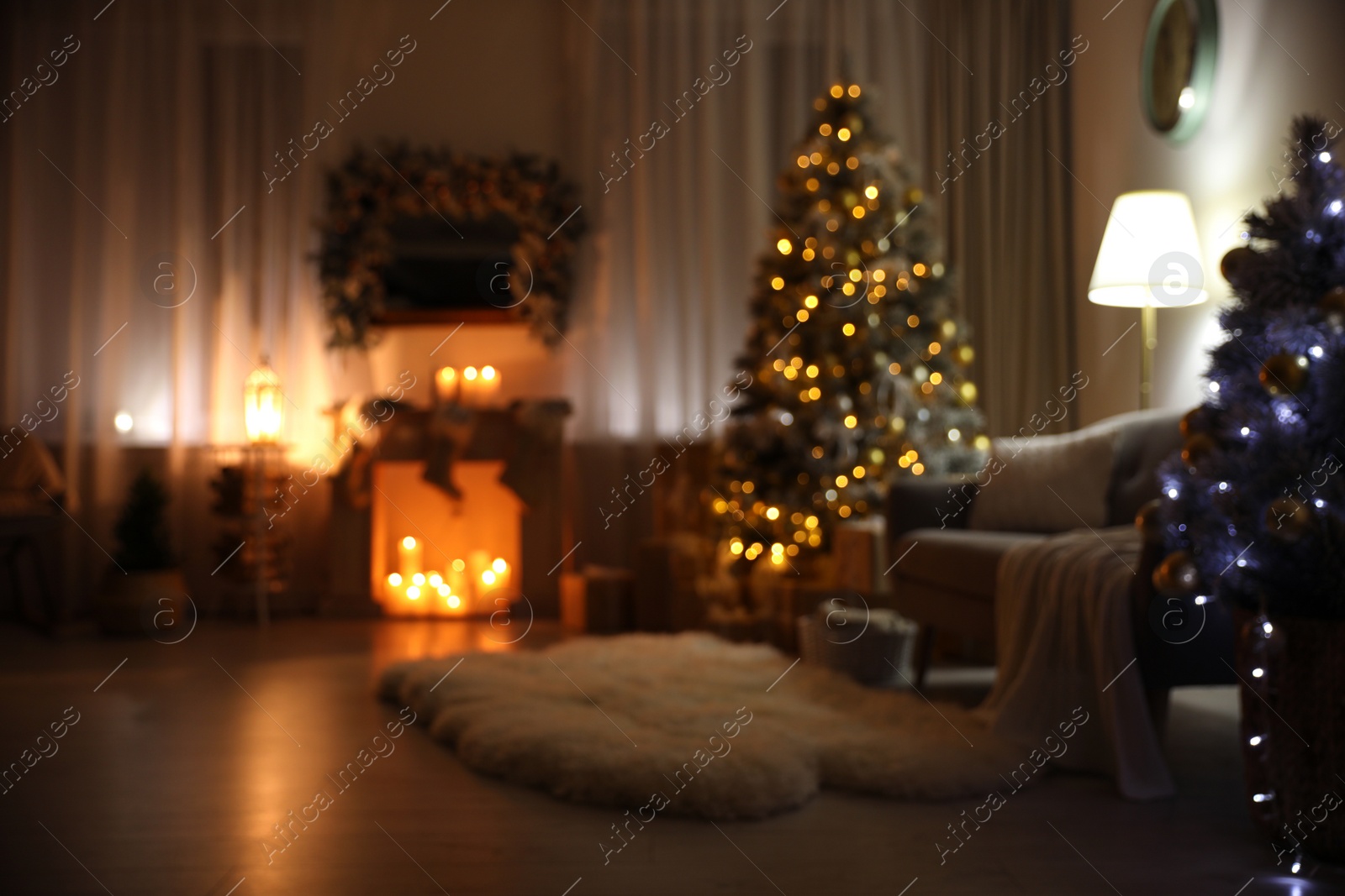 Photo of Blurred view of festive interior with Christmas tree and decorative fireplace