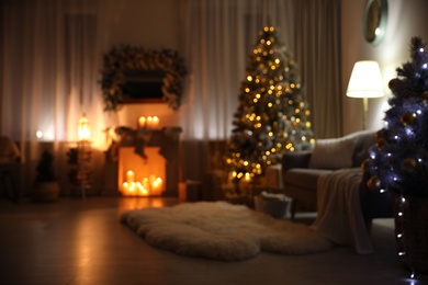 Photo of Blurred view of festive interior with Christmas tree and decorative fireplace