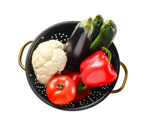 Photo of Colander with fresh vegetables isolated on white, top view