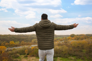 Photo of Man enjoying beautiful nature in mountains, back view