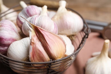 Photo of Fresh garlic in basket, closeup. Organic product