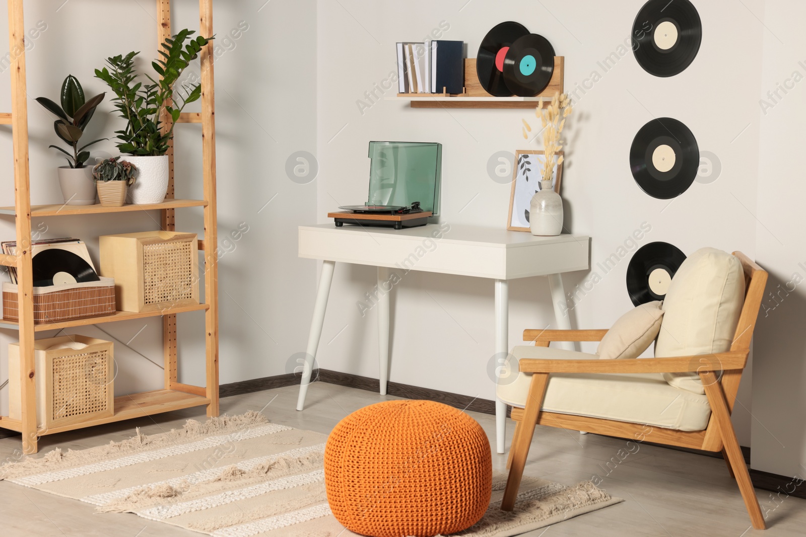 Photo of Room interior with stylish turntable on white table and vinyl records