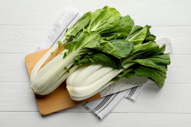 Fresh green pak choy cabbages on white wooden table, top view