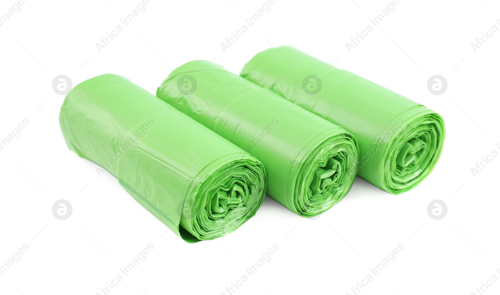 Photo of Rolls of light green garbage bags isolated on white