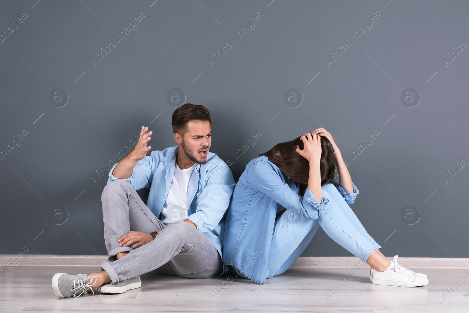 Photo of Young couple having argument indoors. Relationship problems