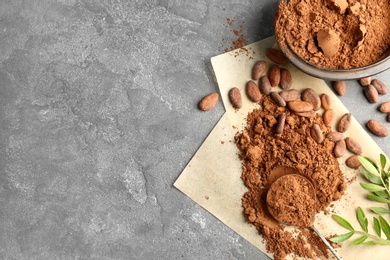 Photo of Flat lay composition with cocoa powder and beans on grey background