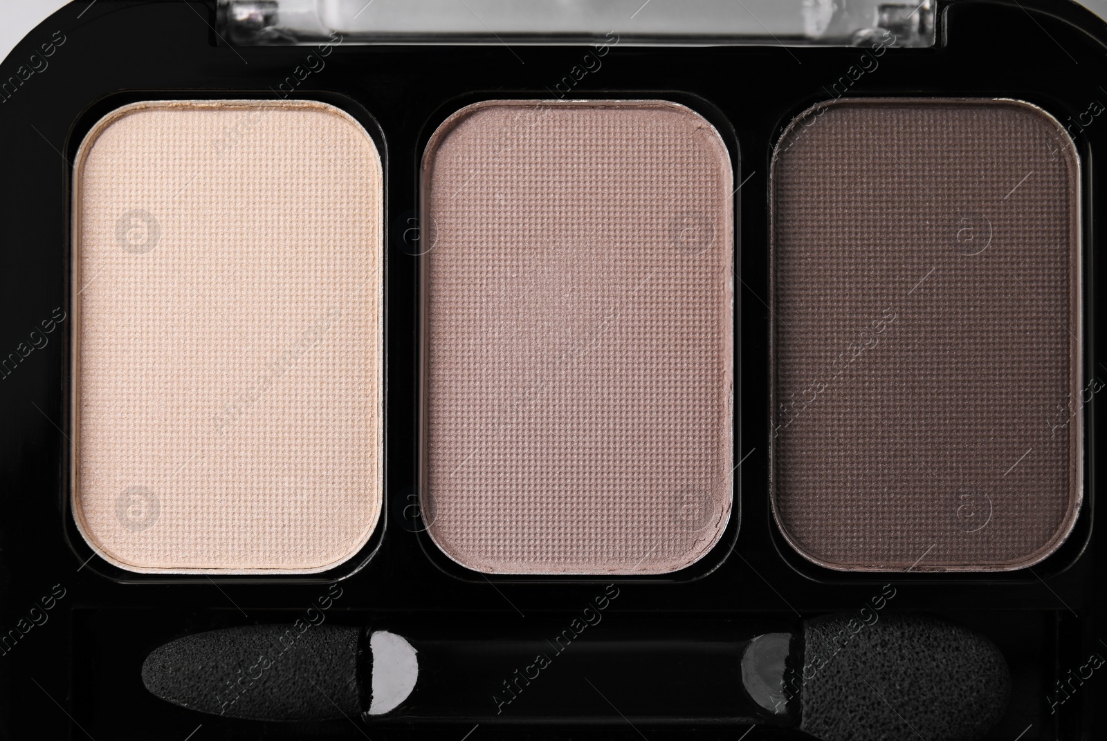 Photo of Beautiful eyeshadow palette with applicator as background, top view. Professional cosmetic product