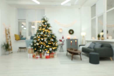 Blurred view of decorated Christmas tree in living room. Interior design