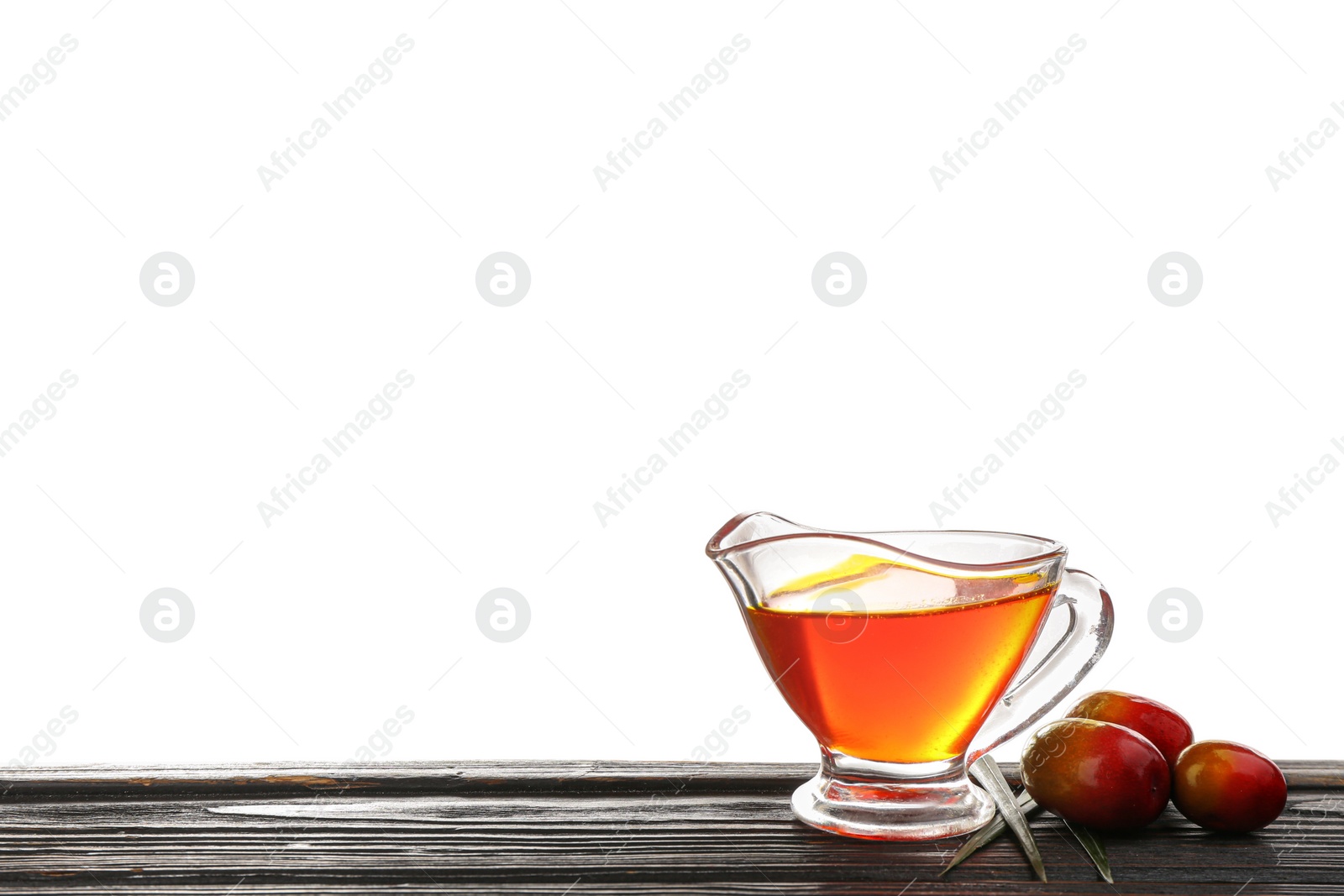 Photo of Palm oil and fruits on black wooden table against white background