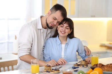 Happy couple spending time together during breakfast at home