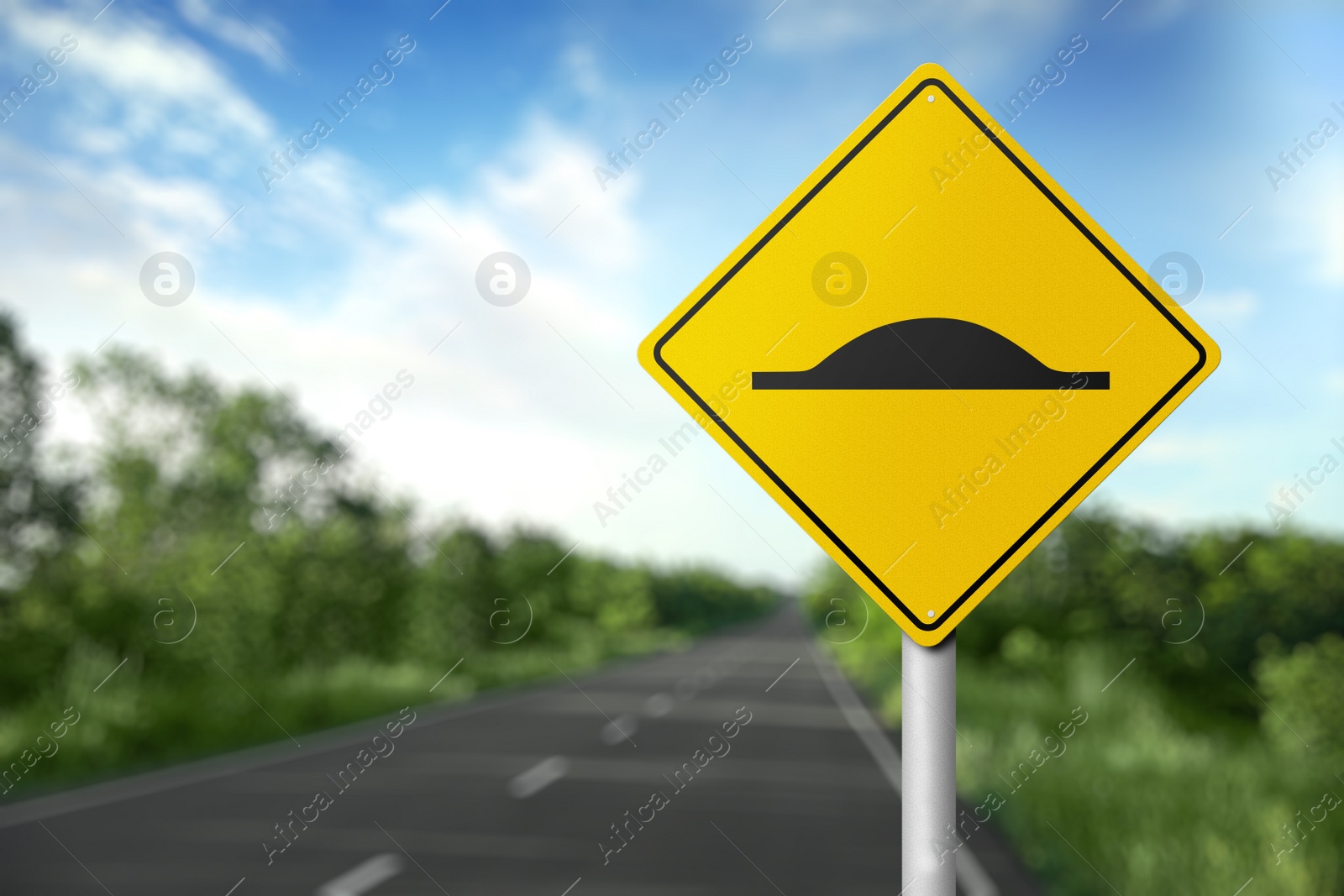 Image of Sign Speed Bump near asphalt road outdoors 