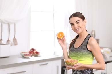 Photo of Young woman in fitness clothes with healthy breakfast at home. Space for text