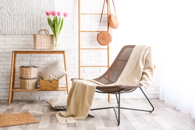 Photo of Stylish living room interior with cozy armchair near brick wall