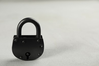 Photo of Vintage padlock on light table. Space for text