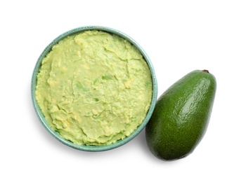 Photo of Bowl of tasty guacamole and whole avocado on white background, top view
