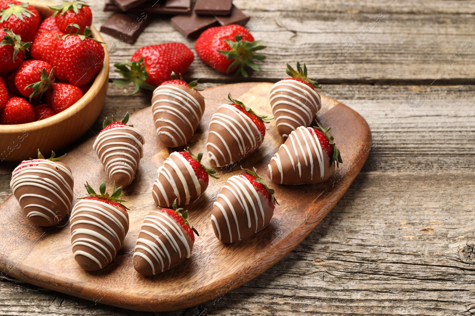 Photo of Delicious chocolate covered strawberries on wooden table. Space for text