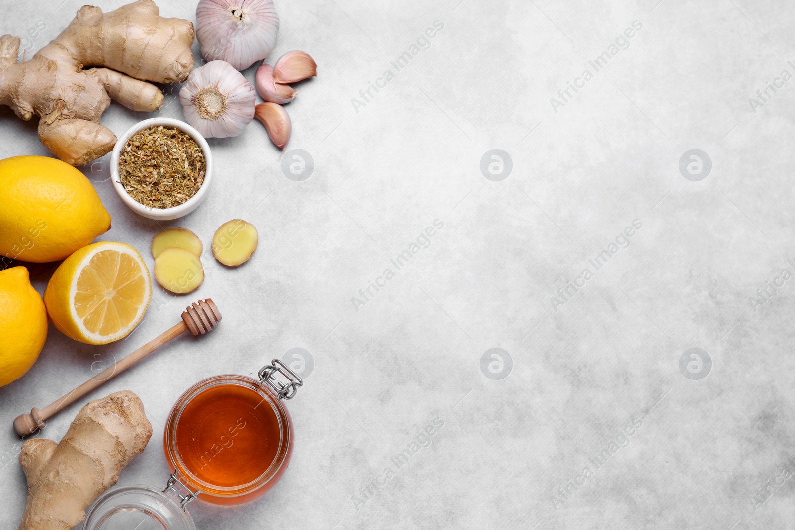 Photo of Different natural cold remedies on light grey table, flat lay with space for text. Cough treatment