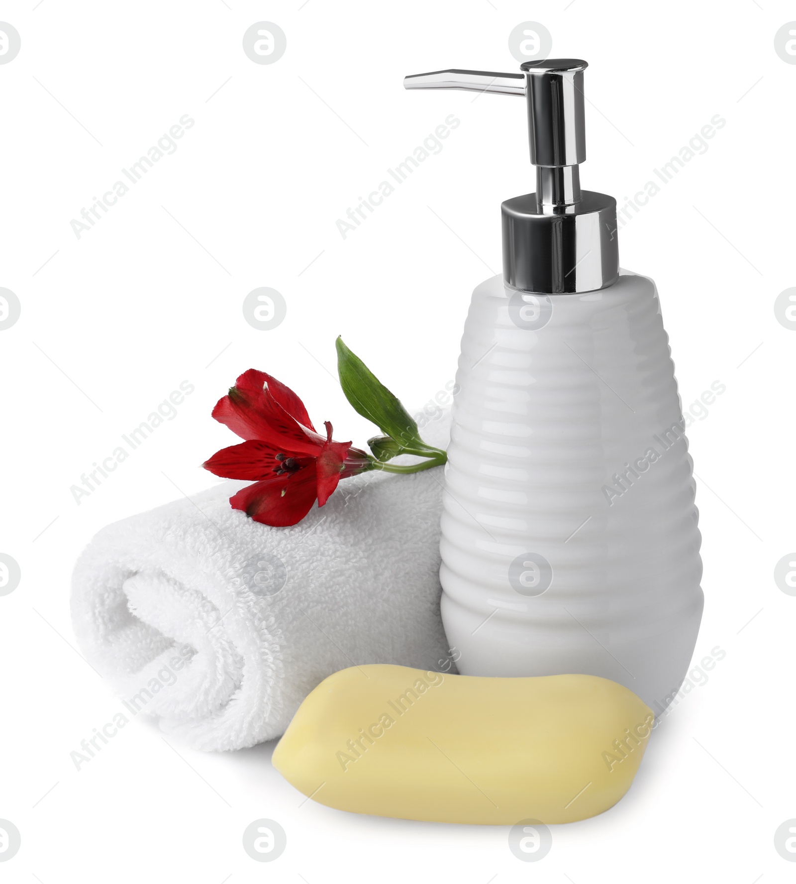 Photo of Soap bar, dispenser and terry towel on white background