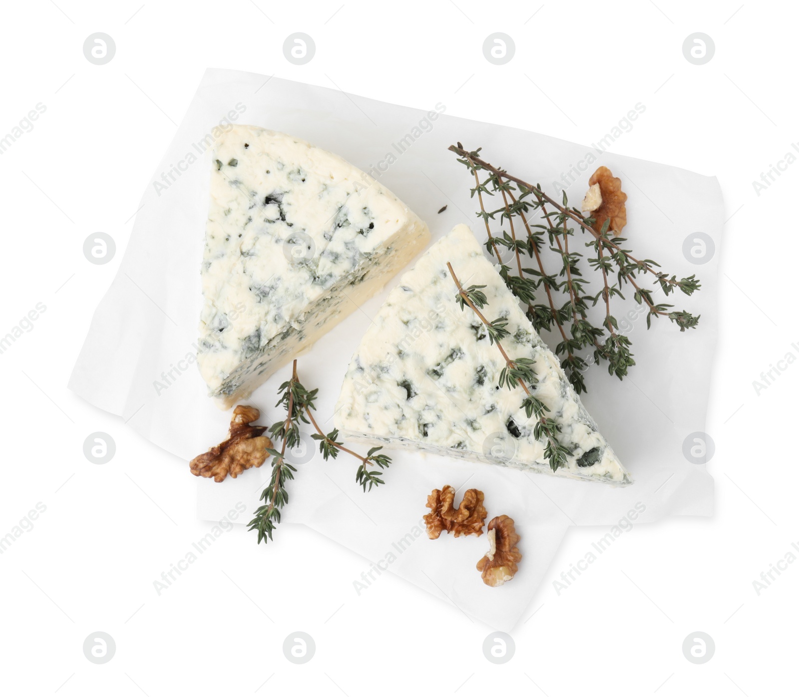 Photo of Tasty blue cheese with thyme and walnuts isolated on white, top view