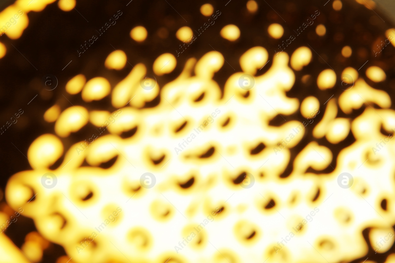 Photo of Blurred view of shiny golden surface as background
