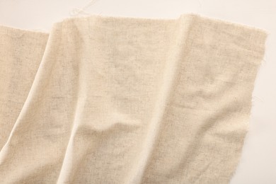 Natural burlap fabric on white background, top view