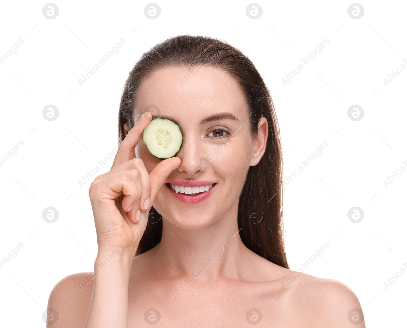 Photo of Beautiful woman covering eye with piece of cucumber on white background