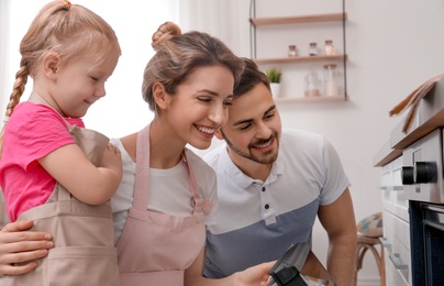 Photo of Happy family baking food in oven at home