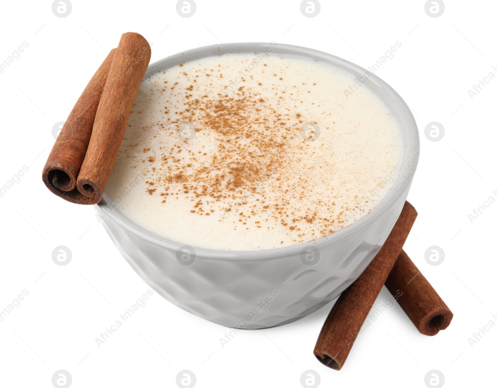 Photo of Delicious semolina pudding with cinnamon in bowl isolated on white