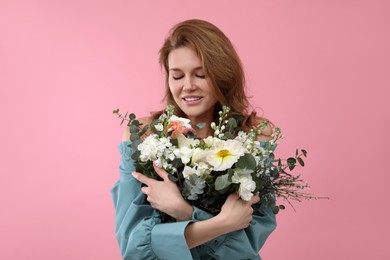 Photo of Beautiful woman with bouquet of flowers on pink background