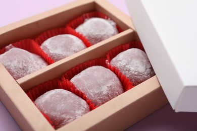 Box of delicious mochi on light background, closeup. Traditional Japanese dessert