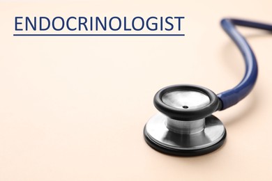 Endocrinologist. Stethoscope on beige background, closeup. Space for text