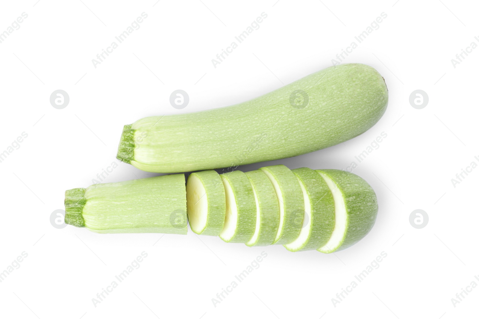 Photo of Cut and whole green ripe zucchinis on white background, top view