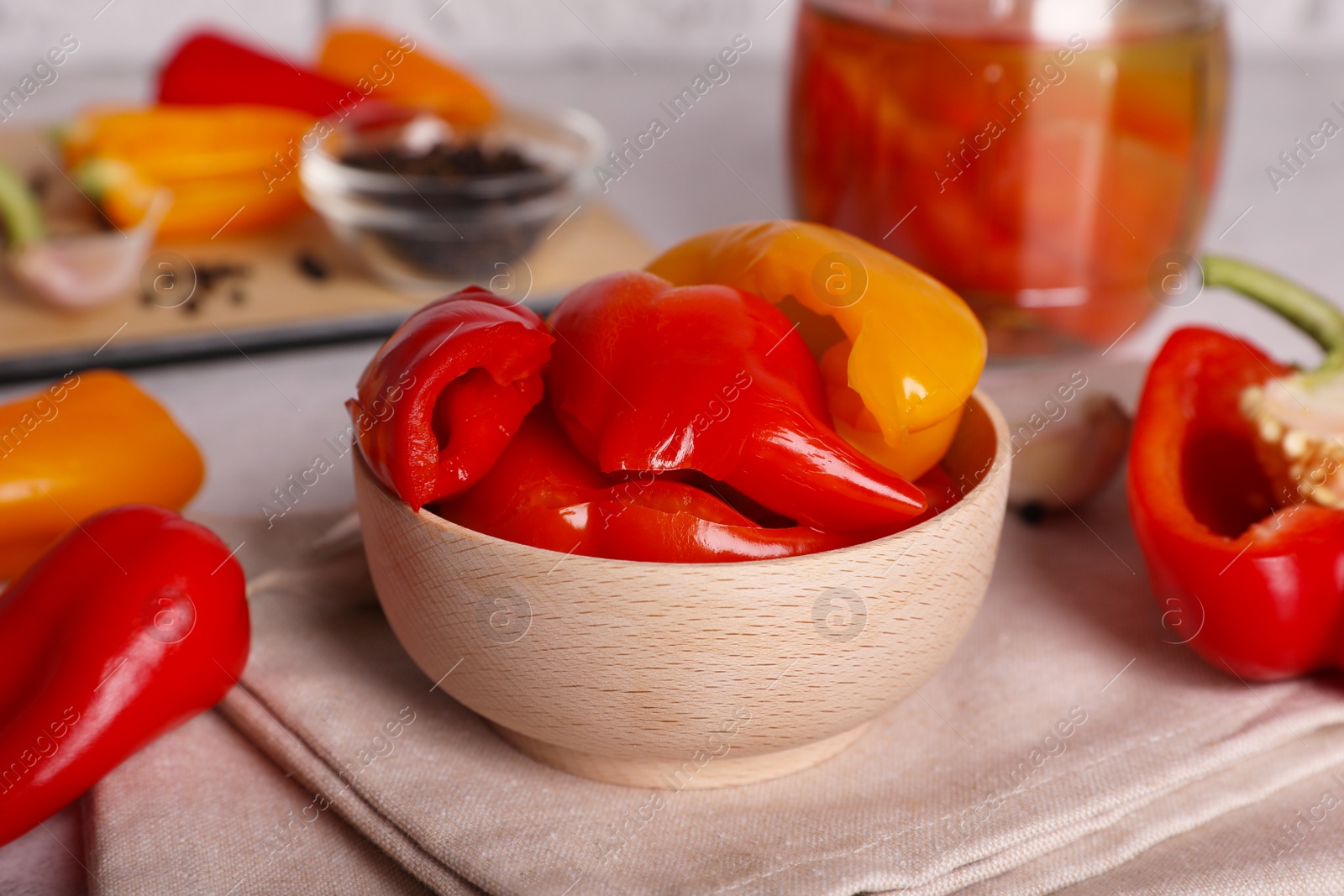 Photo of Tasty pickled peppers and fresh vegetables on table, closeup